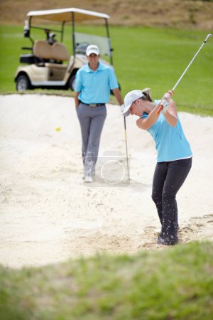 Photo for Golf course, sports and woman golfer playing sport for fitness, workout and exercise with a swing on a sand. Wellness, person and athlete training in action or outdoor game with a club stroke. - Royalty Free Image
