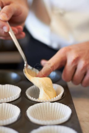 Photo for Closeup, hands and muffin dough in tray with baker, small business owner and professional chef. Cooking, bakery and cake in baking pan for food, job or start process for cupcake in restaurant kitchen. - Royalty Free Image