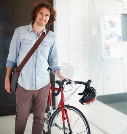 Photo for Portrait, bicycle and business man in office for creative startup, happy career and internship opportunity. Young person, designer or employee with bike, carbon footprint and startup job in workplace. - Royalty Free Image