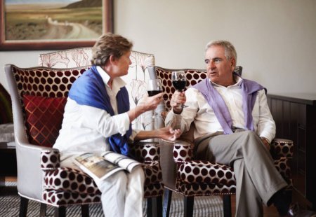 Photo for Toast, love and an old couple drinking wine in their hotel room while on holiday or vacation together. Retirement, sofa or relax with a senior man and woman bonding at a luxury resort for romance. - Royalty Free Image