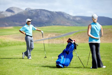 Photo for Couple, teamwork or golfer playing golf for fitness, workout or exercise together on green course field. Healthy people, woman golfing or athlete training in action or sports game driving with clubs. - Royalty Free Image