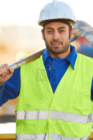 Photo for Portrait, construction and man with a shovel, industry and architecture with skills, renovation and vest. Face, male person or employee with tools, equipment or safety with labor, spade or protection. - Royalty Free Image