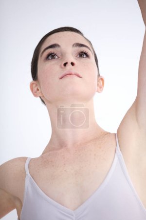 Photo for Dance, closeup of ballerina woman and in a white background isolated. Ballet or dancer, balance fitness and female person dancing alone in a studio backdrop for health wellness or creative art. - Royalty Free Image
