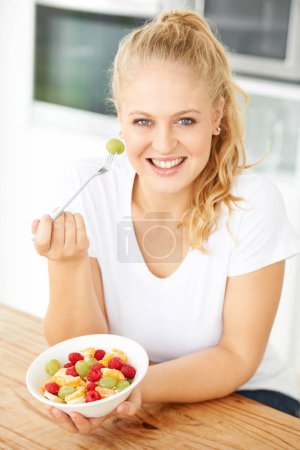 Photo for Fruit, bowl and portrait of woman eating healthy lunch or breakfast meal or diet in the morning in her home kitchen. Nutrition, health and vegan person smile and happy for salad, food and self care. - Royalty Free Image