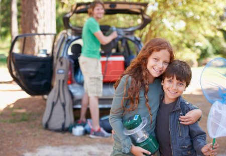Photo for Happy siblings, portrait and hug for road trip, camping or family vacation together in nature. Sister hugging brother with smile and lantern for camp adventure, travel or holiday getaway in a forest. - Royalty Free Image