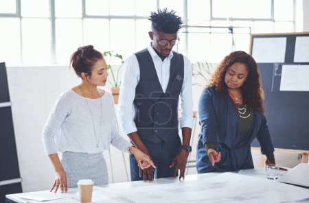 Photo for Making their plans go bigger than imagined. a team of professionals working on blueprints in an office - Royalty Free Image
