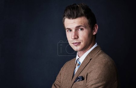 Photo for Be better than the rest. Studio shot of a young businessman against a dark background - Royalty Free Image