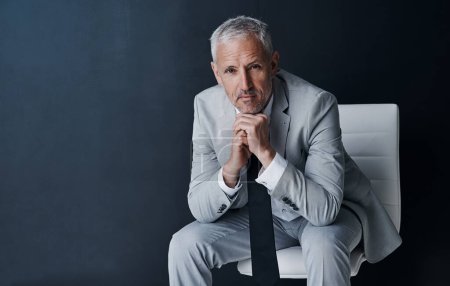 Photo for Attitude sets the tone for success. Studio portrait of a mature businessman against a dark background - Royalty Free Image