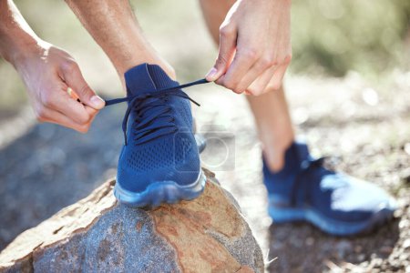 Photo for Man, hands and tie shoes for running, fitness or getting ready for workout, hiking or walk in nature. Hand of male person, hiker or runner tying shoe for trekking, run or cardio exercise outdoors. - Royalty Free Image