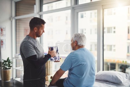 Photo for Explaining the diagnosis. a young male physiotherapist assisting a senior patient in recovery - Royalty Free Image