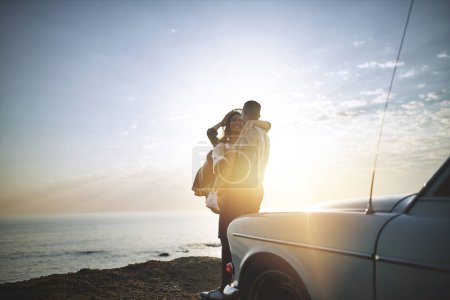 Photo for We fell in love where the sky touches the sea. a young couple making a stop at the beach while out on a road trip - Royalty Free Image