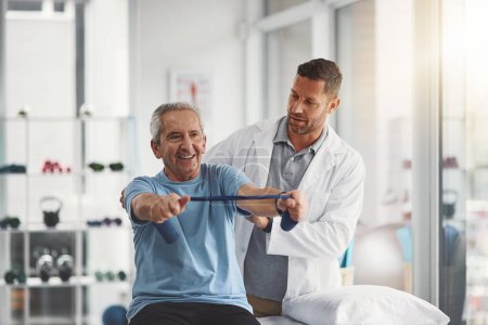 Photo for His strength and happiness grows with each day. a young male physiotherapist assisting a senior patient in recovery - Royalty Free Image