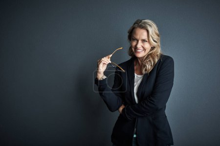 Photo for Ive committed myself to success right from the beginning. Studio portrait of a mature businesswoman posing against a grey background - Royalty Free Image
