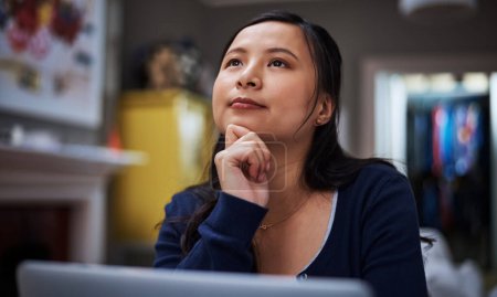 Photo for Thinking about her next move. an attractive young female entrepreneur looking thoughtful while working from home - Royalty Free Image