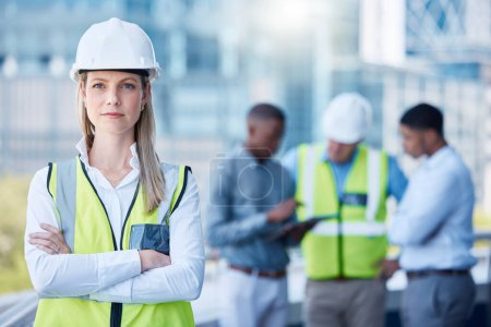 Photo for Portrait, arms crossed and a serious woman construction worker outdoor on a building site with her team in the background. Management, leadership and a confident female architect standing outside. - Royalty Free Image