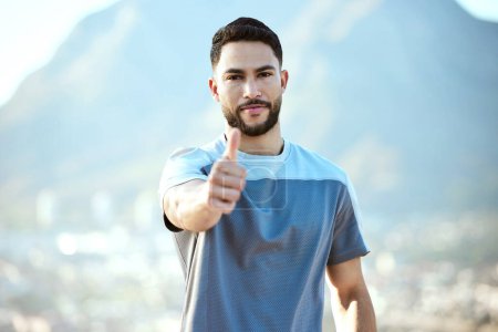 Photo for Fitness, man and outdoor with thumbs up for a run or workout with a smile for motivation. Portrait and hand of male athlete runner on mountain road for training, exercise or health and wellness goals. - Royalty Free Image