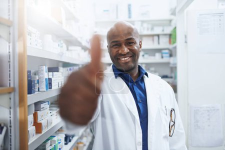Photo for Youll give his service a thumbs up. a confident pharmacist showing thumbs up in a chemist - Royalty Free Image