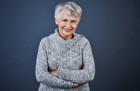 Photo for Aging is a wonderful process. Studio shot of a cheerful elderly woman standing with her arms folded while looking at the camera - Royalty Free Image