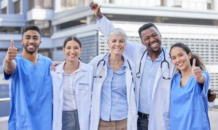 Photo for Doctor team, city and thumbs up with hug and celebration for healthcare and wellness work. Hospital, nursing and happy clinic group with success and support together with smile, motivation and trust. - Royalty Free Image