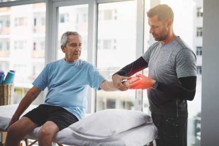 Photo for Loosening up all those stiff muscles. a young male physiotherapist assisting a senior patient in recovery - Royalty Free Image
