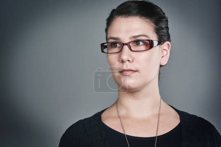 Photo for Clear and confident in the way forward. Studio shot of a confident young businesswoman posing against a grey background - Royalty Free Image