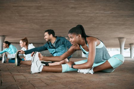 Photo for Group, training and friends stretching as a fitness club for sports, health and wellness in an urban town together. Sport, commitment and people exercise or team doing warm up workout in a city. - Royalty Free Image
