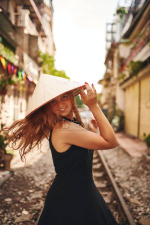 Foto de Feliz es el que ha viajado. una joven con un sombrero cónico mientras explora una ciudad extranjera - Imagen libre de derechos