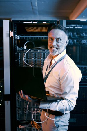 Photo for Leave all troubleshooting to me. Portrait of a mature man using a laptop while working in a server room - Royalty Free Image