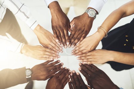 Photo for We each bring a unique skill set to the team. Closeup shot of a group of businesspeople joining their hands together - Royalty Free Image