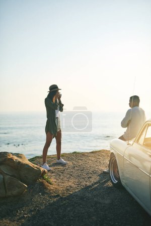 Photo for Pose for me, sexy. a young couple making a stop at the beach while out on a roadtrip - Royalty Free Image