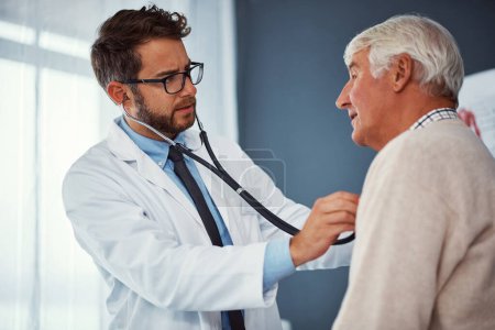 Photo for Taking care of the elderly. a doctor examining a senior patient with a stethoscope in a clinic - Royalty Free Image