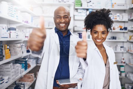 Photo for We prescribe what is good for you. two pharmacists showing thumbs up - Royalty Free Image