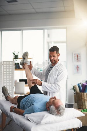 Photo for Muscles have to be rebuilt with great care. a young male physiotherapist assisting a senior patient in recovery - Royalty Free Image