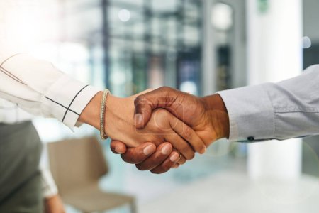 Photo for Sounds like a perfect deal to me. Closeup shot of two businesspeople shaking hands in an office - Royalty Free Image