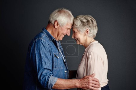 Photo for You still have my heart. Studio shot of an affectionate senior couple posing against a grey background - Royalty Free Image