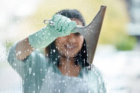 Photo for Housekeeping, foam and woman cleaning the window with equipment by her home or apartment. Female maid, cleaner or housewife washing the glass door with detergent product for bacteria, dirt or dust - Royalty Free Image