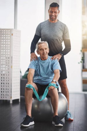 Photo for He can truly be proud of what he has achieved. a young male physiotherapist assisting a senior patient in recovery - Royalty Free Image