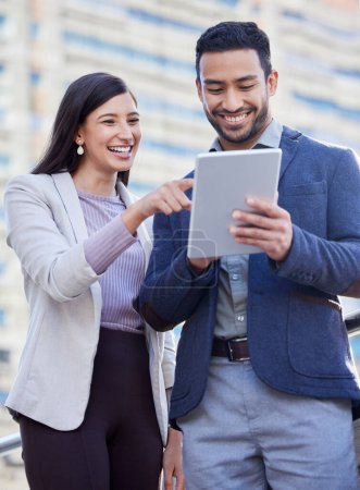 Photo for Business people, tablet and team outdoor in a city with internet connection for social media. A happy man and woman together on urban background with tech for networking, communication or online app. - Royalty Free Image