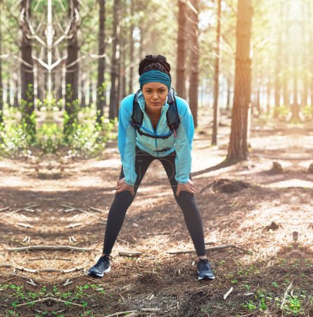 Photo for Dream big and start now. Full length portrait of an athletic young woman out for a jog in the woods - Royalty Free Image