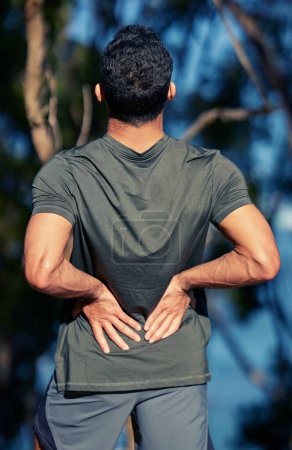 Photo for Man, back pain and fitness injury outdoor after accident, exercise or sports workout. Spine, problem and male athlete with arthritis, fibromyalgia emergency or muscle inflammation for wound in forest. - Royalty Free Image