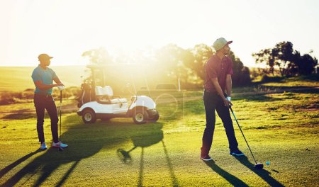 Photo for Lifes a pitch, and then you putt. two friends playing a round of golf out on a golf course - Royalty Free Image