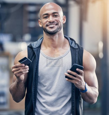 Photo for Ecommerce, portrait of man with smartphone and credit card at the gym with a lens flare. Health wellness, workout and happy male athlete with cellphone for online shopping with bank information. - Royalty Free Image