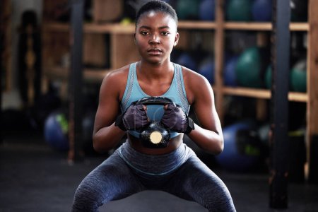 Photo for Fitness, kettlebell squat or portrait of black woman in training, workout or bodybuilding exercise for grip. Body builder, power or strong sports athlete with at gym to start lifting heavy weights. - Royalty Free Image