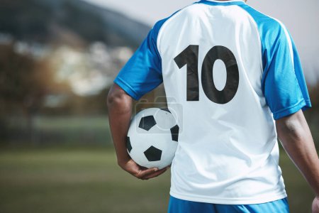 Photo for Soccer ball, sports and man with uniform number on a field for exercise, fitness and training outdoor. Football club, pitch and event or game with athlete person and mockup for sport competition. - Royalty Free Image