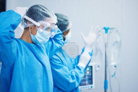 Photo for Doctors in surgery, healthcare and surgical hygiene start with PPE and collaboration in operation theatre in hospital. Medical team, health insurance and safety gear with surgeon people in clinic. - Royalty Free Image