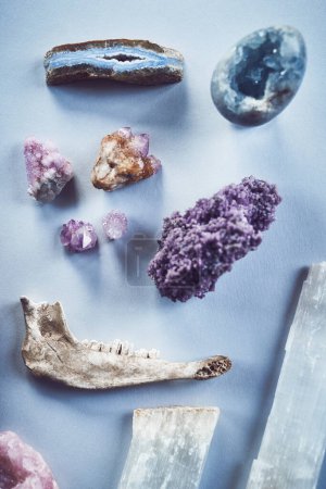 Photo for You may only choose one. High angle shot of a table filled with different types of crystals inside during the day - Royalty Free Image