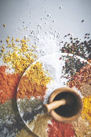 Photo for Ready for a stew filled with flavor. a pestle and mortar with an assortment of spices scattered around it - Royalty Free Image