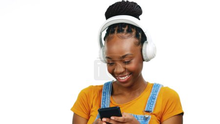 Photo for Black woman listening to music with headphones, smartphone and dancing isolated on white background. Happy female, radio streaming with fun and enjoy playlist with audio subscription and mockup. - Royalty Free Image