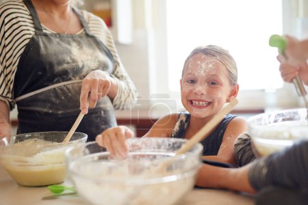 Photo for Portrait, playing or messy girl baking in kitchen with a young kid smiling with flour on a dirty face at home. Smile, happy or parent cooking or teaching a fun daughter to bake for child development. - Royalty Free Image