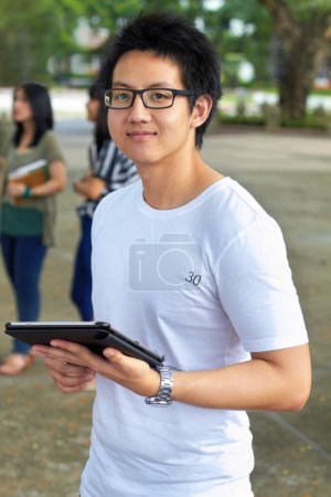 Photo for Asian man, college student and tablet in outdoor portrait with smile for study, education and social media app. Japanese gen z person, digital touchscreen and learning at university, campus or school. - Royalty Free Image
